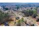 Aerial view showcasing the house location amidst neighborhood houses with proximity to wooded areas and community streets at 192 Pecan Dr, Canton, GA 30114