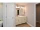 Bright bathroom featuring a double vanity with modern faucets and updated lighting fixtures at 192 Pecan Dr, Canton, GA 30114