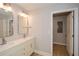 Bright bathroom featuring a double vanity with modern faucets and updated lighting fixtures at 192 Pecan Dr, Canton, GA 30114