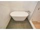 Modern freestanding bathtub with stylish fixtures set against a backdrop of marble-patterned tiles at 192 Pecan Dr, Canton, GA 30114