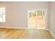 Neutral toned bedroom featuring hardwood floors, a sliding glass door, and a large window at 192 Pecan Dr, Canton, GA 30114