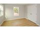 Comfortable bedroom featuring hardwood floors, a bright window, and a spacious double-door closet at 192 Pecan Dr, Canton, GA 30114