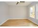 Spacious bedroom with light gray walls, two windows, wood-look floors, ceiling fan, and white trim at 192 Pecan Dr, Canton, GA 30114