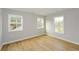 Bright bedroom with ample natural light, showcasing modern hardwood floors and neutral paint tones at 192 Pecan Dr, Canton, GA 30114