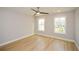 Well-lit bedroom with ceiling fan and scenic views from the double windows at 192 Pecan Dr, Canton, GA 30114