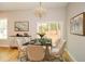 Elegant dining room with modern chandelier, marble table, plush chairs, and bright natural light at 192 Pecan Dr, Canton, GA 30114