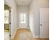 Bright entryway featuring wood-look floors, white trim, and a view of the front door and hallway at 192 Pecan Dr, Canton, GA 30114