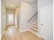 Bright entryway featuring wood-look floors, white trim, staircase, and a view of the front door at 192 Pecan Dr, Canton, GA 30114
