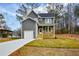 Charming two-story home with gray siding, a front porch, manicured lawn, and an attached garage at 192 Pecan Dr, Canton, GA 30114