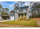 Charming two-story home with gray siding, a front porch, manicured lawn, and an attached garage at 192 Pecan Dr, Canton, GA 30114