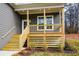 Inviting front porch with wood columns and railings, complemented by newly installed stairs and landscaping at 192 Pecan Dr, Canton, GA 30114