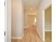 Bright hallway featuring wood-look floors, white trim, neutral paint, and a view to other rooms at 192 Pecan Dr, Canton, GA 30114