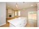 Open-concept kitchen with island, stainless steel appliances, and hardwood floors that flow into living space at 192 Pecan Dr, Canton, GA 30114