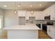 Beautiful kitchen with stainless steel appliances, white cabinets, and large quartz island at 192 Pecan Dr, Canton, GA 30114