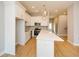 Bright kitchen with white cabinets, stainless appliances, white quartz island, and hardwood floors at 192 Pecan Dr, Canton, GA 30114