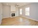 Spacious living room with fireplace, natural light, and modern ceiling fan at 192 Pecan Dr, Canton, GA 30114