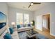 Bright living room with two windows, fan, two couches, blue accent pillows and a stylish blue area rug at 192 Pecan Dr, Canton, GA 30114