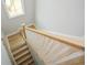 Wooden stairway with white railing featuring natural light from a window, creating an inviting transition at 192 Pecan Dr, Canton, GA 30114