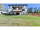 Wide backyard view showing the home's covered patios and spacious grassy area at 2255 Buford Dam Rd, Buford, GA 30518