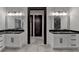 Elegant bathroom featuring dual vanities with black marble countertops and modern fixtures at 2255 Buford Dam Rd, Buford, GA 30518