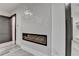 Detailed wall paneling, modern linear fireplace, and sleek flooring in a bedroom at 2255 Buford Dam Rd, Buford, GA 30518