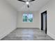 Bedroom boasts stylish gray floors, white walls, a modern ceiling fan and large window at 2255 Buford Dam Rd, Buford, GA 30518