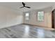 Bright bedroom with two windows and modern ceiling fan, spacious and well-lit at 2255 Buford Dam Rd, Buford, GA 30518