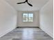 Bright bedroom featuring sleek gray flooring, a contemporary ceiling fan, and a large window at 2255 Buford Dam Rd, Buford, GA 30518