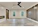 Spacious bedroom featuring a modern ceiling fan, stylish accent wall, and beautiful wood-look flooring at 2255 Buford Dam Rd, Buford, GA 30518