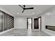 Well-lit bedroom with decorative walls, modern ceiling fan, and sleek flooring at 2255 Buford Dam Rd, Buford, GA 30518