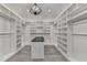 Spacious walk-in closet with custom shelving, drawers, and overhead lighting at 2255 Buford Dam Rd, Buford, GA 30518