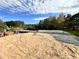 Construction of a house's foundation, set against a backdrop of lush trees and a partly cloudy sky at 2255 Buford Dam Rd, Buford, GA 30518