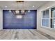 Dining room featuring elegant gold light fixture and a vibrant blue accent wall at 2255 Buford Dam Rd, Buford, GA 30518