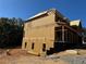 Side view of a house under construction, showing the frame and backyard at 2255 Buford Dam Rd, Buford, GA 30518