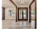 Elegant foyer featuring a modern chandelier, a front door with glass inserts, and light gray floors at 2255 Buford Dam Rd, Buford, GA 30518