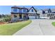 Inviting two-story home features a three-car garage, covered entryway, and a beautifully landscaped lawn at 2255 Buford Dam Rd, Buford, GA 30518