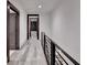 Hallway featuring gray wood-look floors, modern railing, and dark wood trim at 2255 Buford Dam Rd, Buford, GA 30518