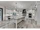 Bright kitchen with white cabinetry, granite countertops, a central island, and modern lighting at 2255 Buford Dam Rd, Buford, GA 30518