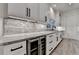 Kitchen area with wine cooler, granite countertops, modern sink and stainless appliances at 2255 Buford Dam Rd, Buford, GA 30518