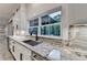 Bright kitchen features stainless steel appliances, granite countertops, and white cabinets at 2255 Buford Dam Rd, Buford, GA 30518