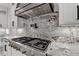 Gourmet kitchen features stainless steel appliances and a decorative tile backsplash at 2255 Buford Dam Rd, Buford, GA 30518