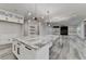 Open concept kitchen with a large island, granite countertops and modern lighting at 2255 Buford Dam Rd, Buford, GA 30518