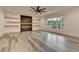 Living room offers a fireplace, floating shelves, and a large window for ample natural light at 2255 Buford Dam Rd, Buford, GA 30518