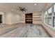 Open living room features a fireplace, floating shelves, ceiling fan and large windows at 2255 Buford Dam Rd, Buford, GA 30518