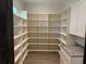 Spacious pantry with custom shelving offers ample storage in this modern home at 2255 Buford Dam Rd, Buford, GA 30518