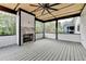 Beautiful outdoor patio featuring a stone fireplace, ceiling fan, and wooded views at 2255 Buford Dam Rd, Buford, GA 30518