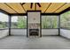 Covered outdoor patio showcasing a stone fireplace and scenic wooded views at 2255 Buford Dam Rd, Buford, GA 30518