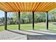 Covered outdoor patio showcasing a stone paver floor, black beams, and backyard view at 2255 Buford Dam Rd, Buford, GA 30518
