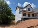 Side view of under construction home showcasing a porch area, windows and wooded lot at 2257 Buford Dam Rd, Buford, GA 30518