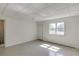 Basement space with light gray carpet, white walls, a window, and a door at 4840 Pisgah Rd, Cumming, GA 30028